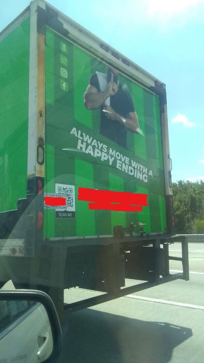 Truck with a man holding a phone, with text 'Always move with a happy ending'.