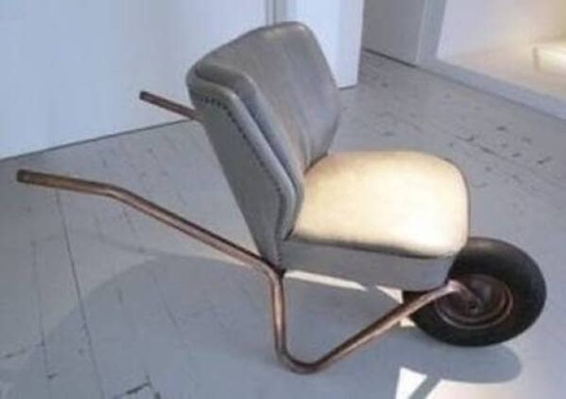 Chair with a wheel at the back and a bent metal frame, resembling a unicycle.