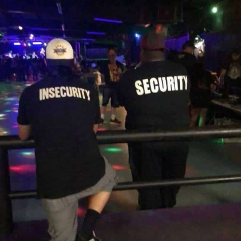 Security and insecurity staff at a nightclub, with colorful lights and people in the background.