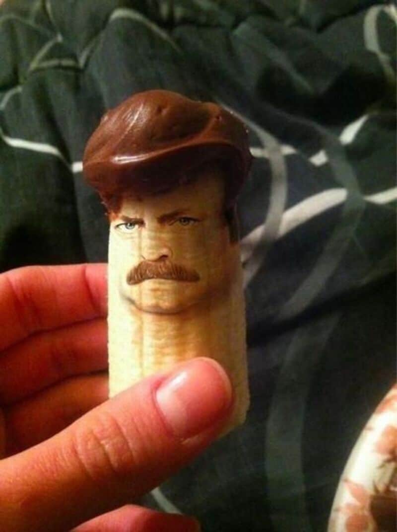Banana with a face and hair resembling a man's face with mustache.