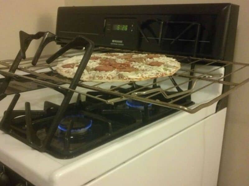 Pizza on a stove with a timer showing 5:26.
