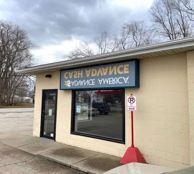 Store with upside-down sign reading 'SEN DANCER' and a no parking sign outside.