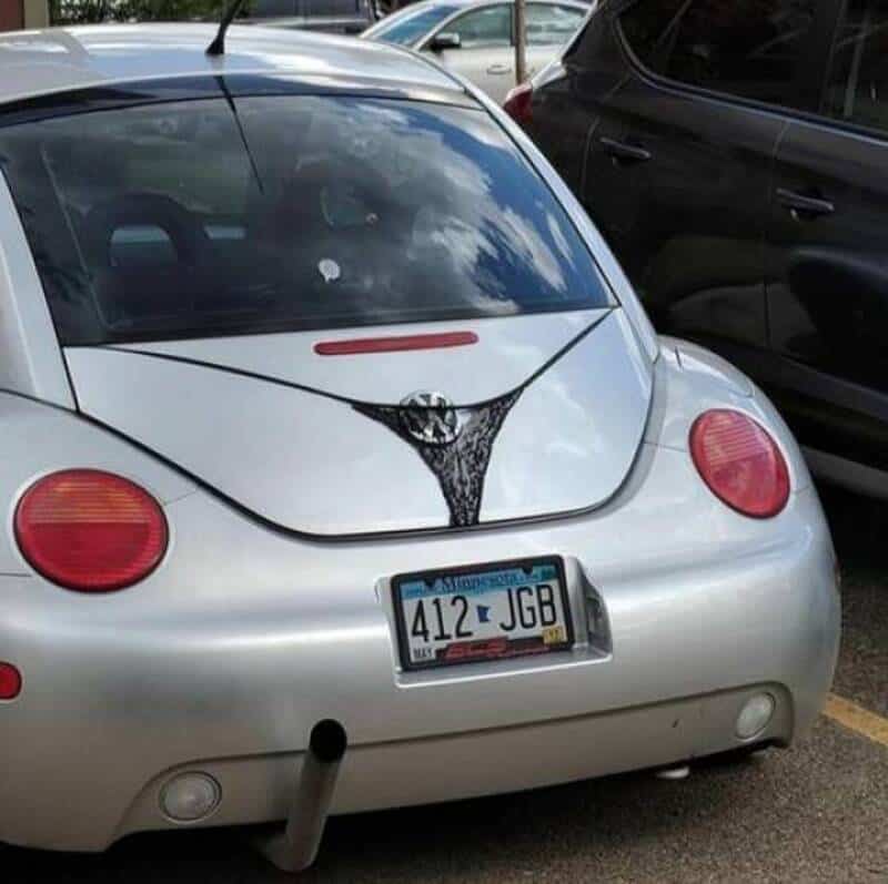 Car with a painted design resembling a woman's cleavage on the trunk.