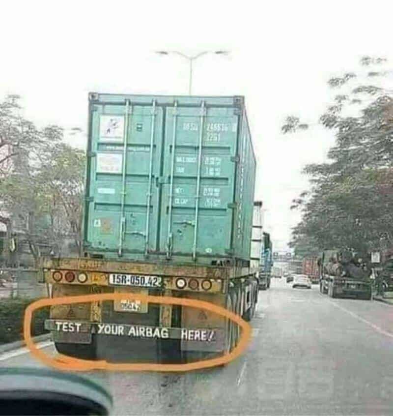 Truck with a sign saying 'TEST YOUR AIRBAG HERE!'.