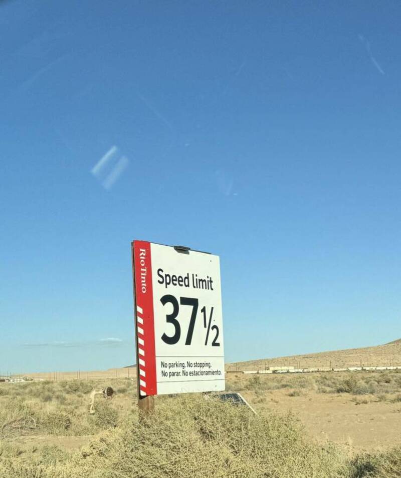 Speed limit 37 1/2 with no parking or stopping in desert landscape.