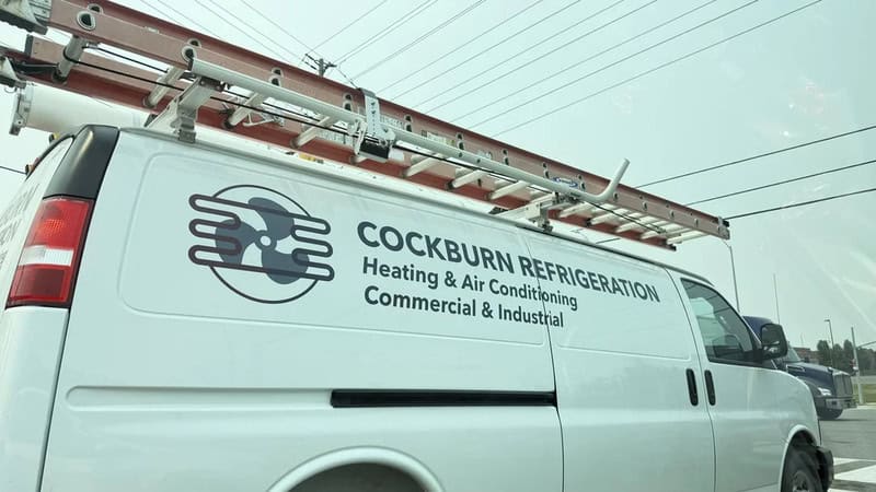 Cockburn Refrigeration van with ladder on top, logo, and text for heating, air conditioning, and工业.