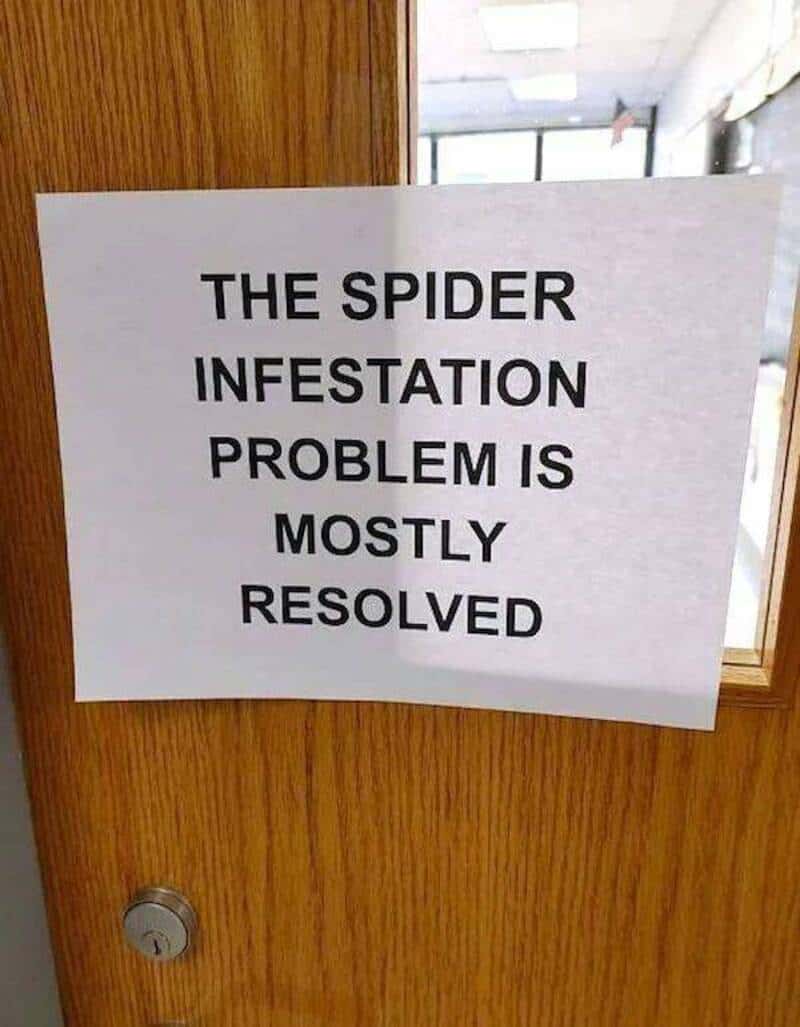 Sign on door says 'The spider infestation problem is mostly resolved'.