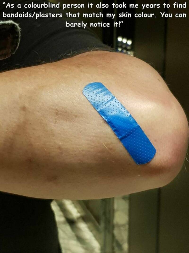 Colorblind person with a blue bandaid on skin, quote about matching skin color.