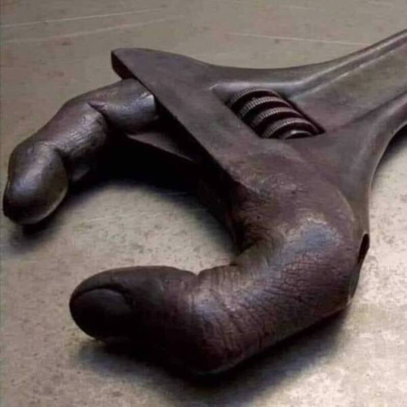 A wrench shaped like a human hand with a thumb and fingers.
