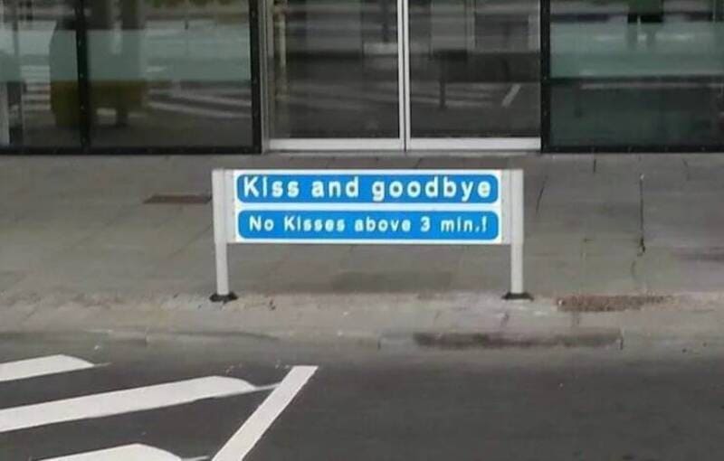 Sign reads 'Kiss and goodbye No Kisses above 3 min.'.