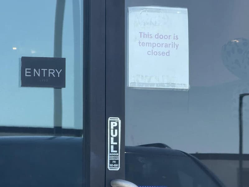 Door with a sign saying 'This door is temporarily closed' and an 'ENTRY' sign.