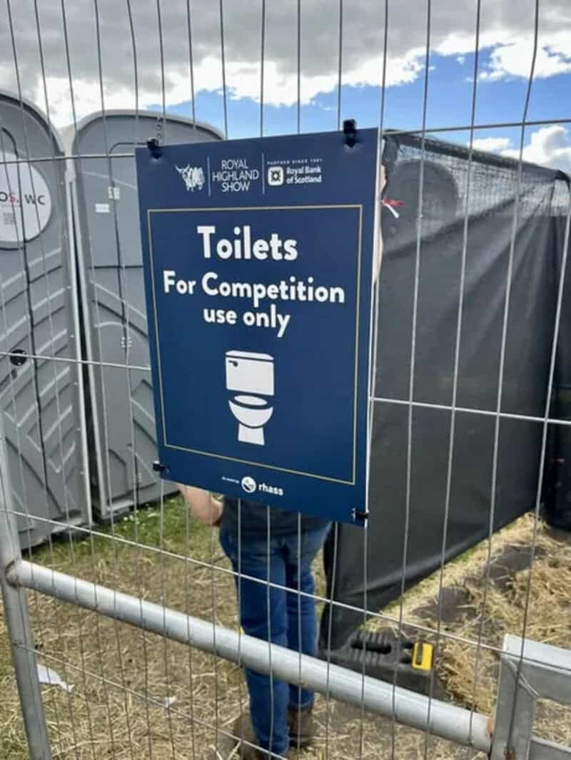 Sign reads 'Toilets for Competition use only' at an outdoor event.