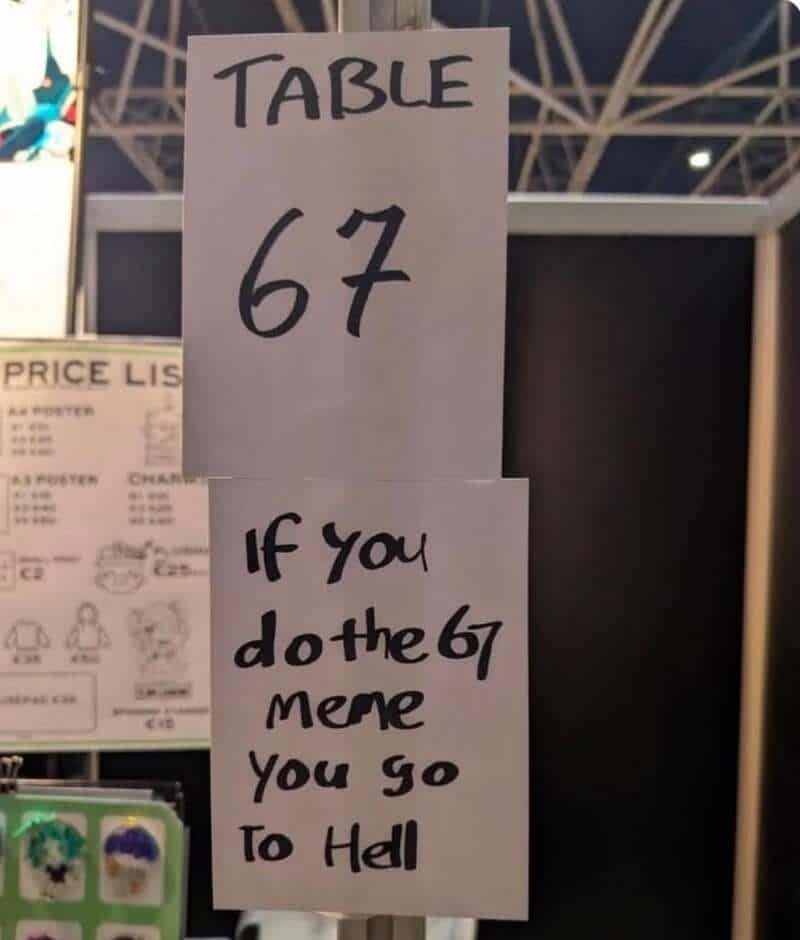 Sign on a table reading 'TABLE 67' and a note saying 'If you do the 67, then you go to Hell'.