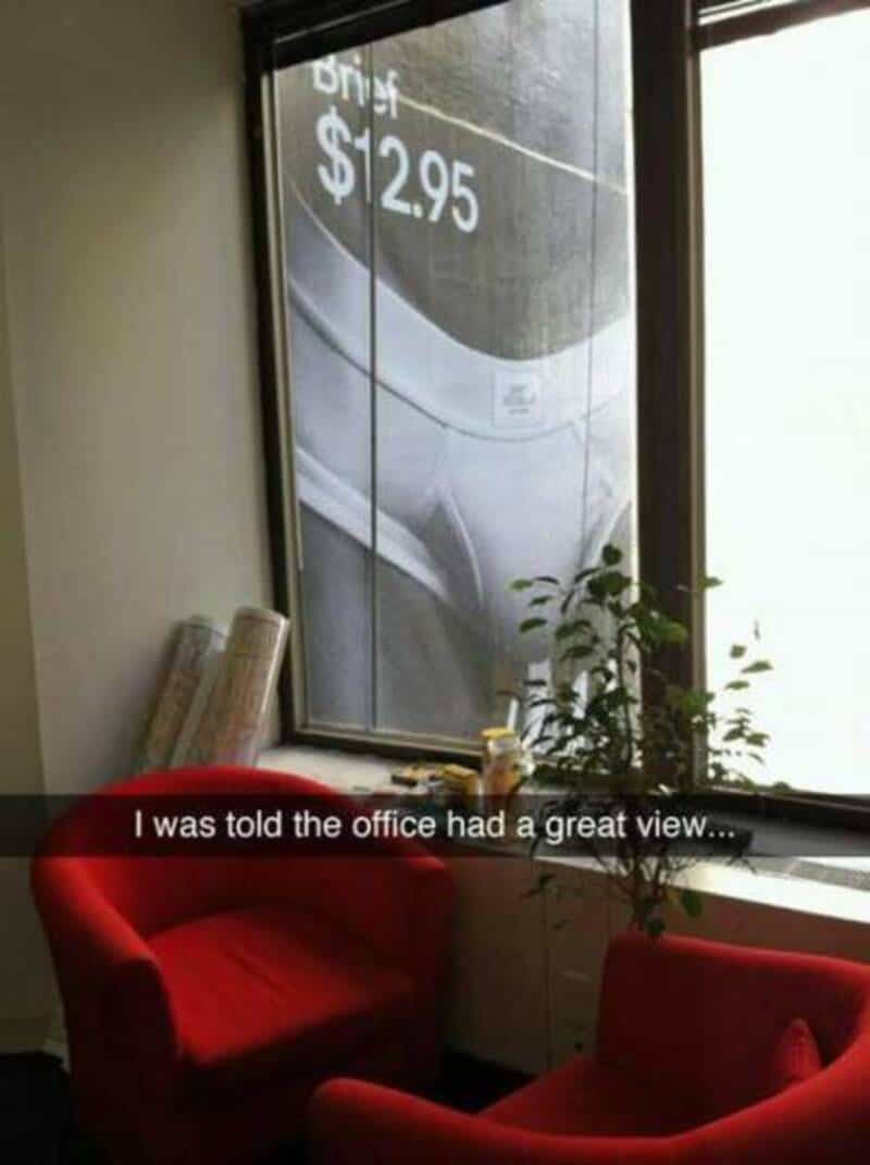 Office view blocked by a large advertisement with a shoe image and price.