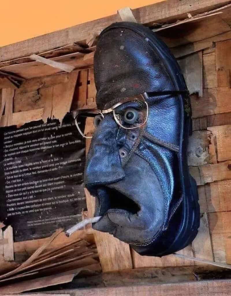 A shoe with glasses, a nose, and a cigarette, resembling a face.