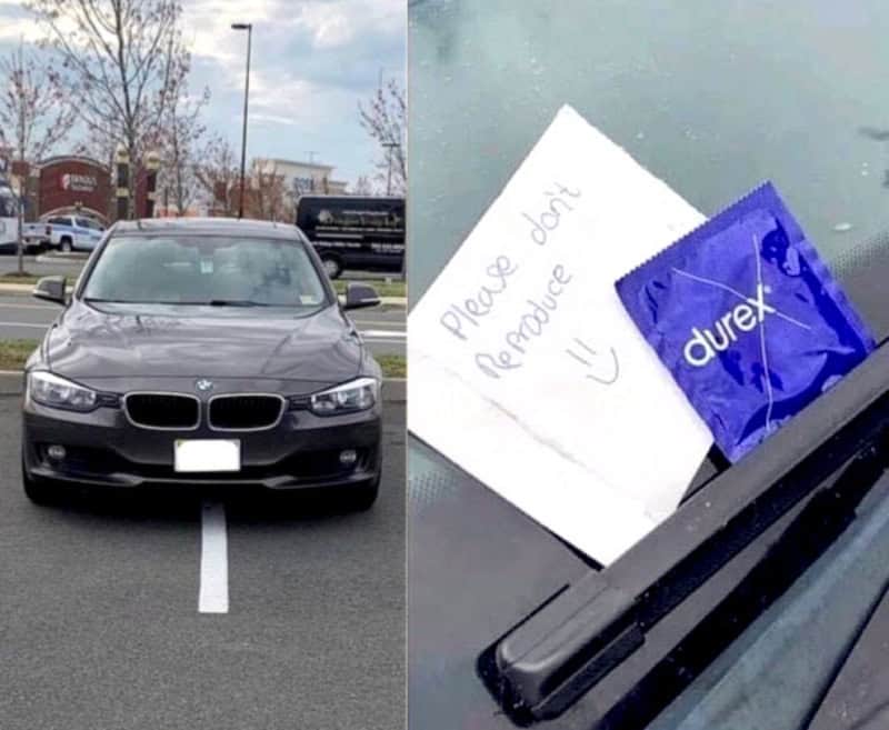 Car parked in a parking lot with a note and condom on the windshield.