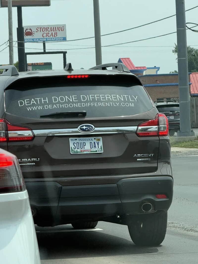 Subaru SUV with a bumper sticker reading 'Death Done Differently' and a 'Soup Day' license plate.
