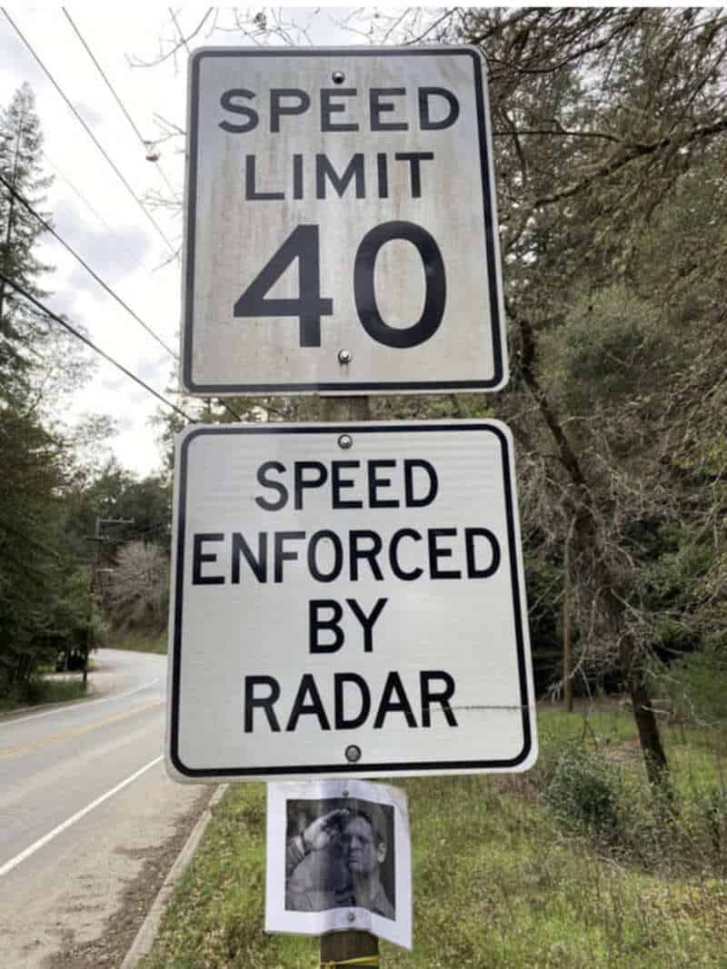 Speed limit 40 sign with a radar enforcement sign below and a photo of a dog at the bottom.