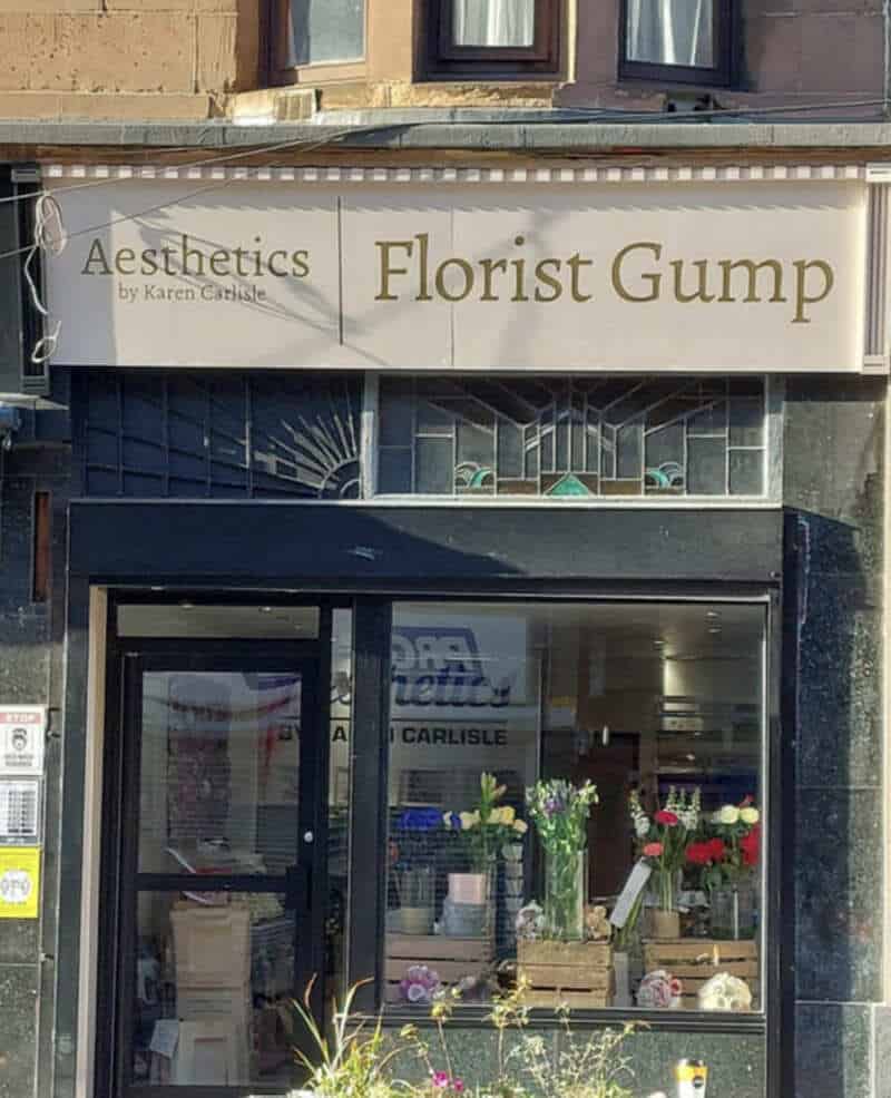 Florist Gump shop sign with flowers visible inside the store.