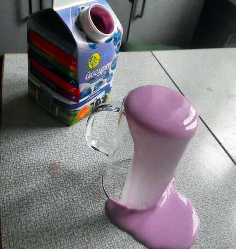 A pink and white plastic object resembling a melting ice cream cone next to a juice box.