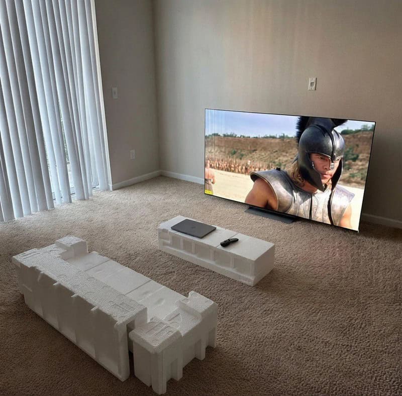 Living room with TV, foam blocks, and a remote, showing a scene from a movie.