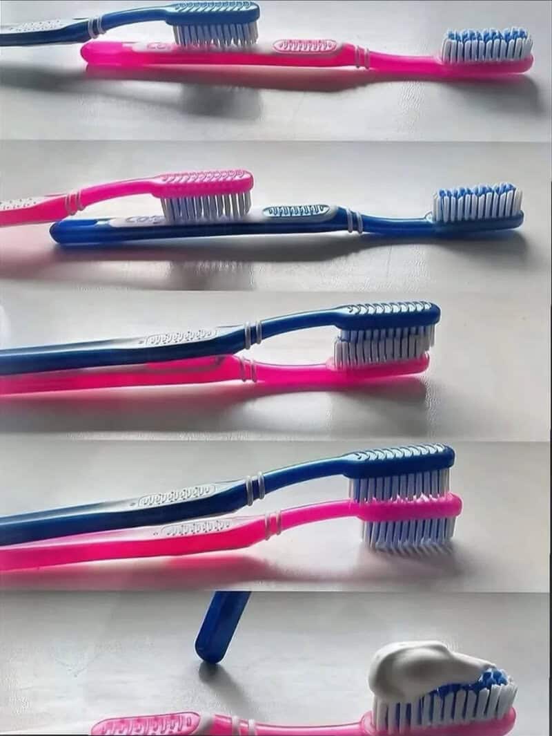 Colorful toothbrushes arranged in a pattern on a white surface.