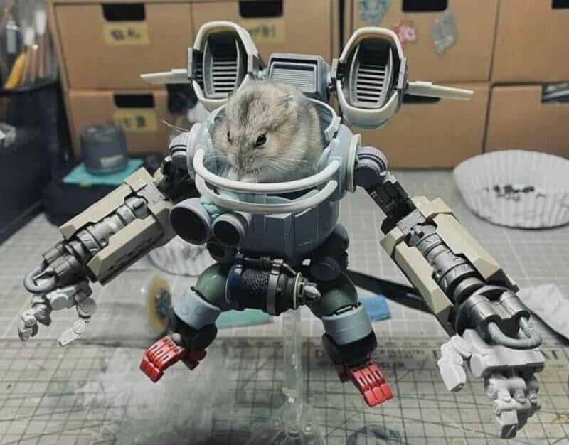 A hamster inside a detailed robot model with mechanical arms and legs.