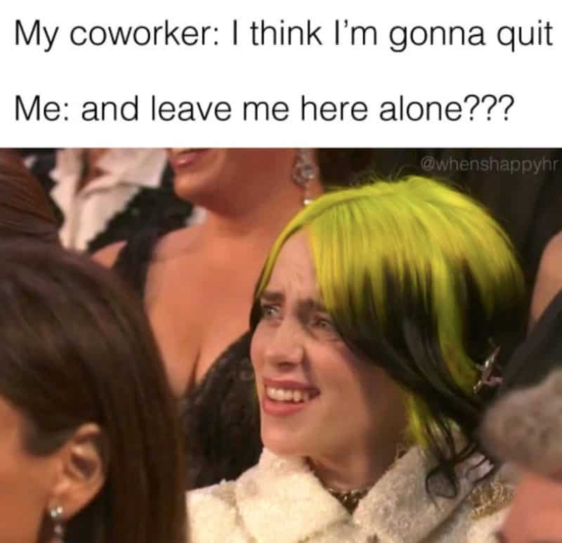 A woman with green and black hair looks distressed at a social event.