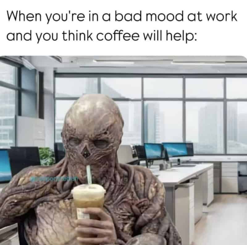 Alien-like creature drinking coffee in an office with the caption about bad mood at work.
