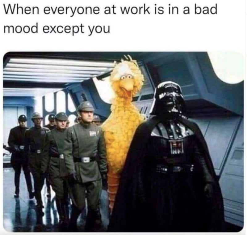 Group of people with a Sesame Street character and Darth Vader in a sci-fi setting.