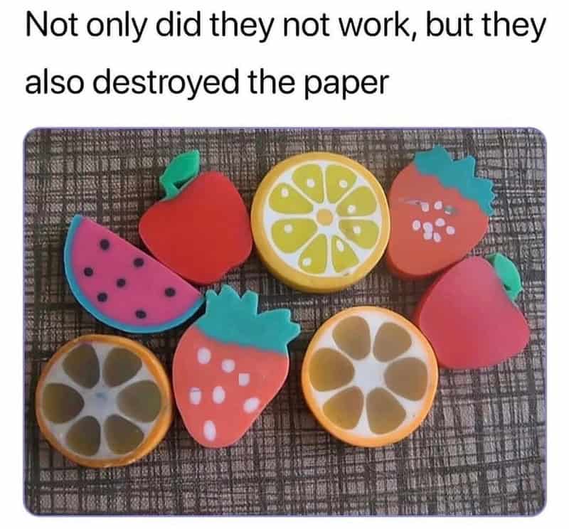 Colorful fruit-shaped erasers on a textured surface with a meme caption.