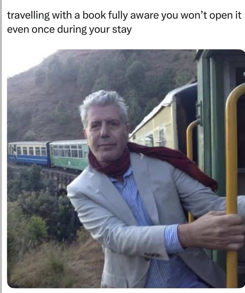 Man in a suit on a train with a humorous caption about traveling with a book.