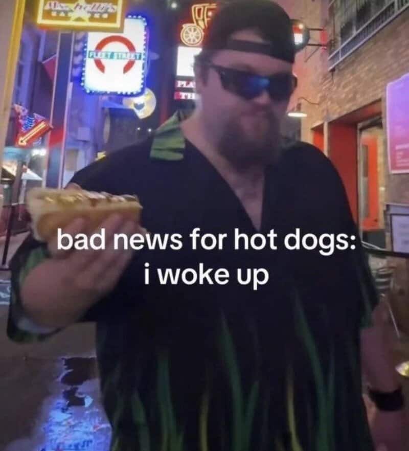 Man in sunglasses holding hot dog with neon signs in background, captioned 'bad news for hot dogs: i.