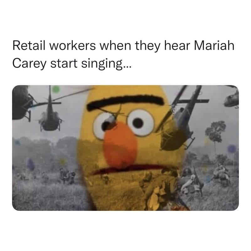 Retail workers react to Mariah Carey singing with helicopters in background.