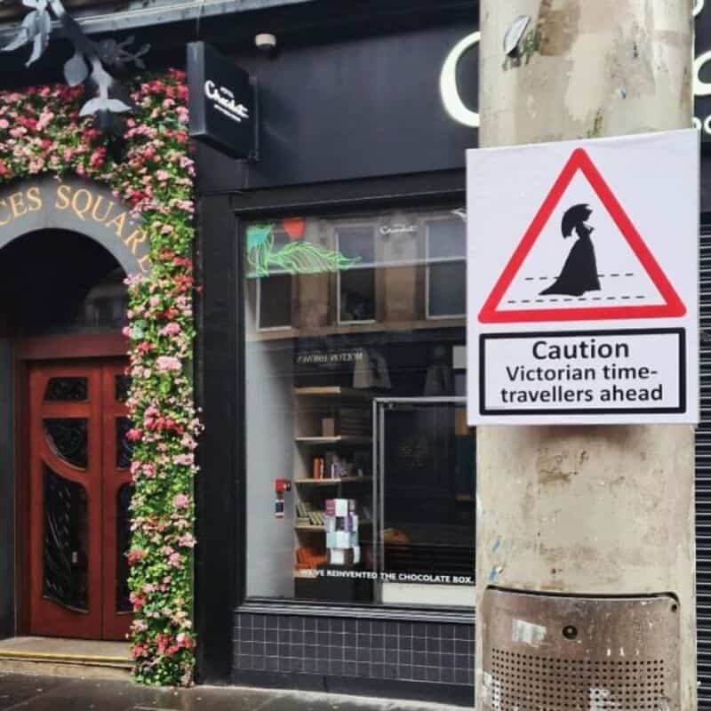 Caution Victorian time-travellers ahead sign on a lamppost.