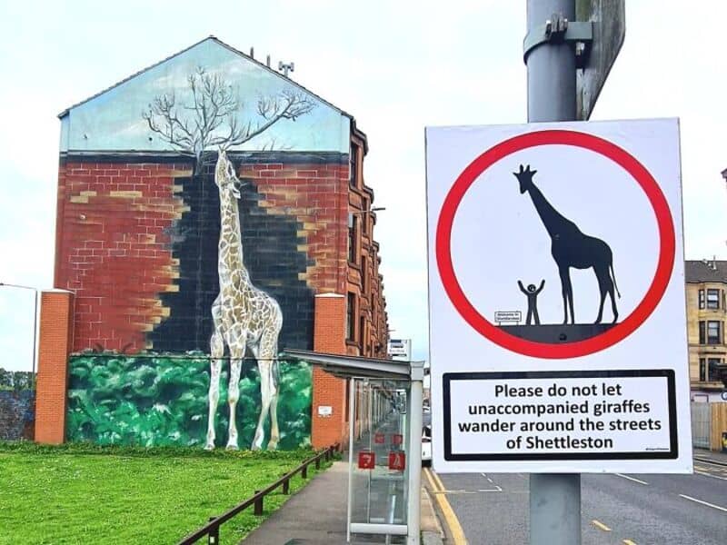 Sign warns not to let unaccompanied giraffes wander around streets of Shettleston.