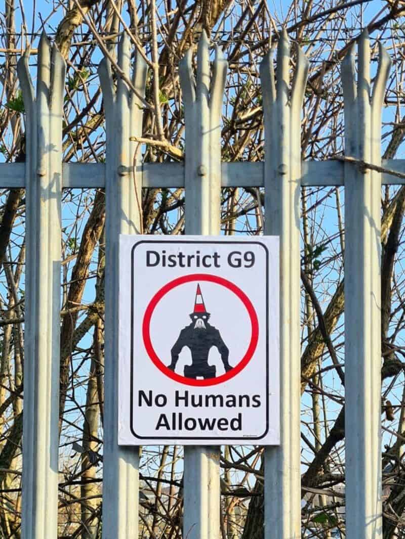 Sign reads 'District G9 No Humans Allowed' with a robot illustration.