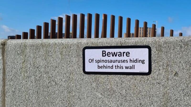 Beware of spinosaures hiding behind this wall sign.