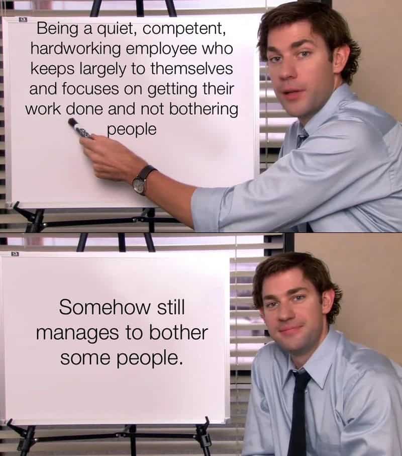 Man points at whiteboard with text about quiet, competent employee, then smiles.