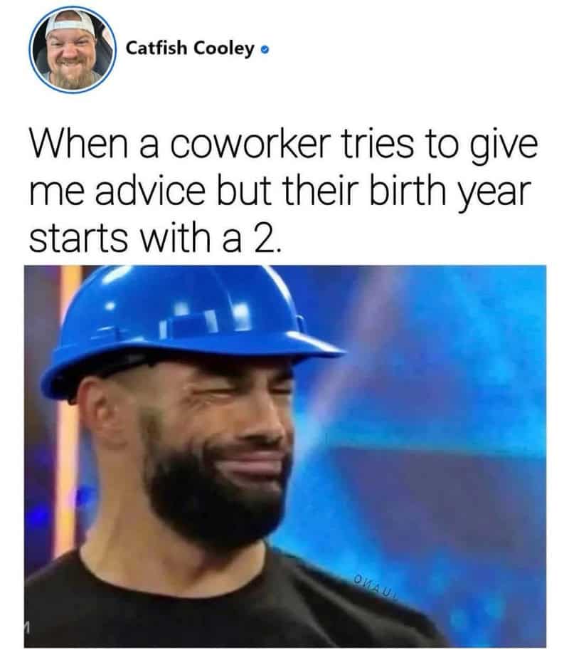 Man wearing a blue construction helmet with a humorous facial expression.