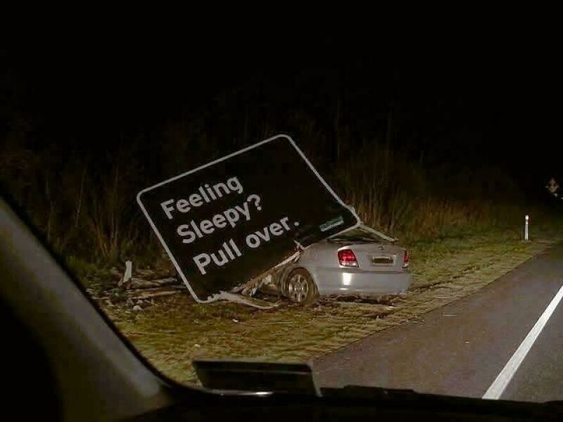 Car crashed into a sign that says 'Feeling Sleepy? Pull over.'.