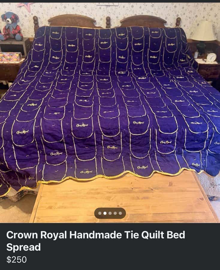 Crown Royal tie-dye quilt bedspread in purple with gold accents, spread on a bed.