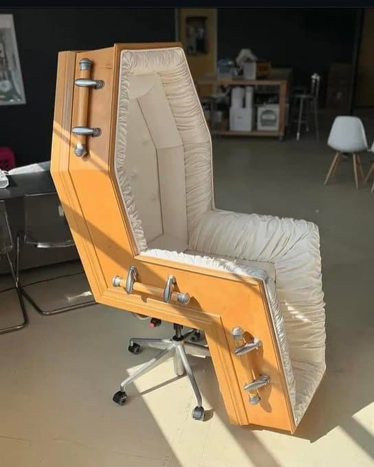 A chair with a coffin-like design, wooden exterior, and cushioned interior.
