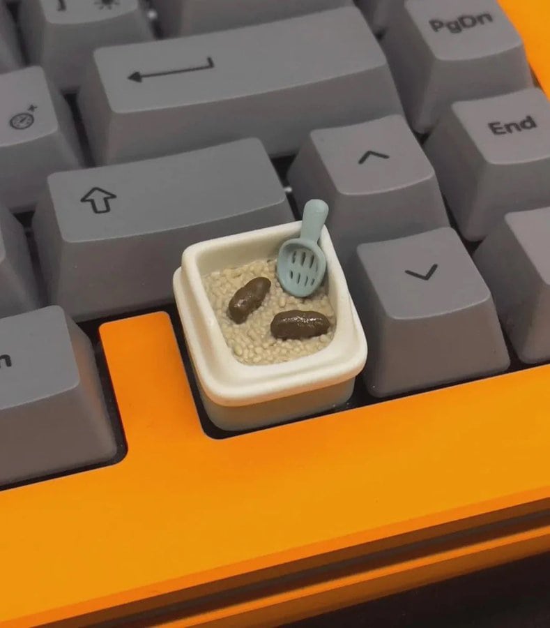 Miniature food in a keyboard keycap with a tiny spoon and beans.