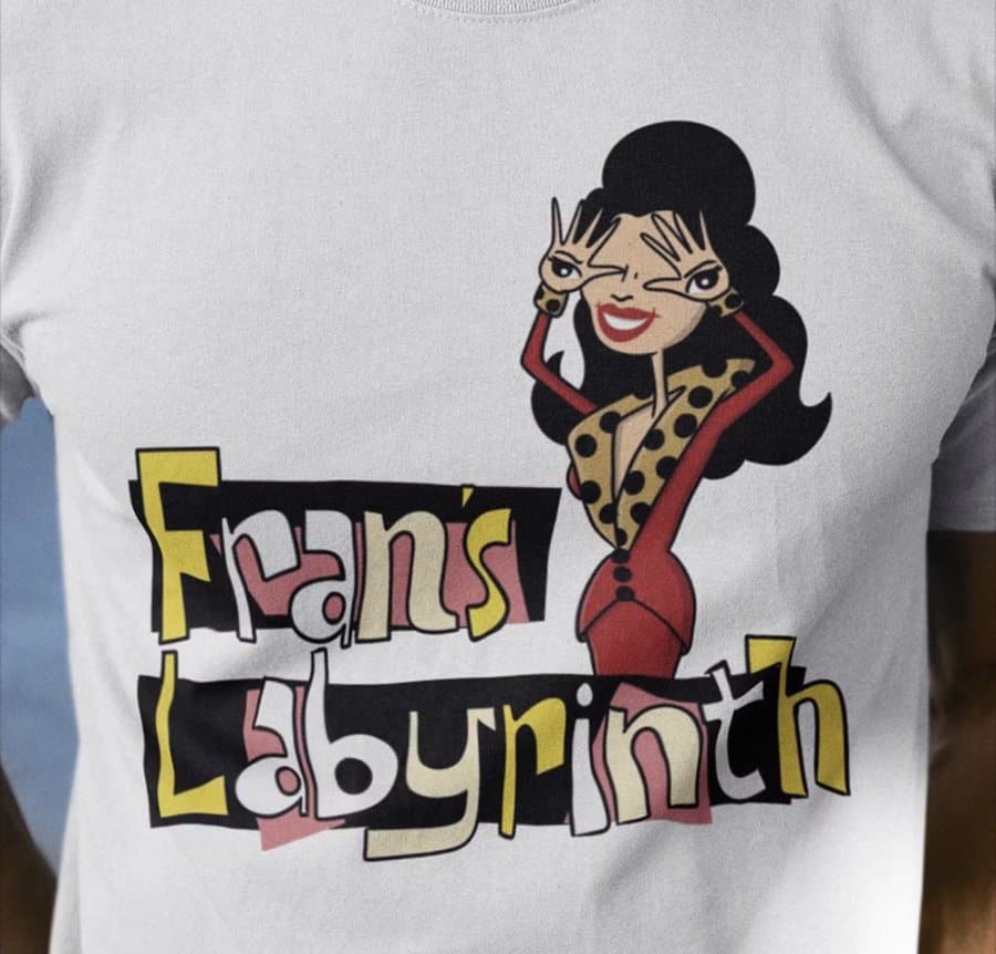 T-shirt with a cartoon woman and the text 'Fan's Labyrinth' in colorful letters.