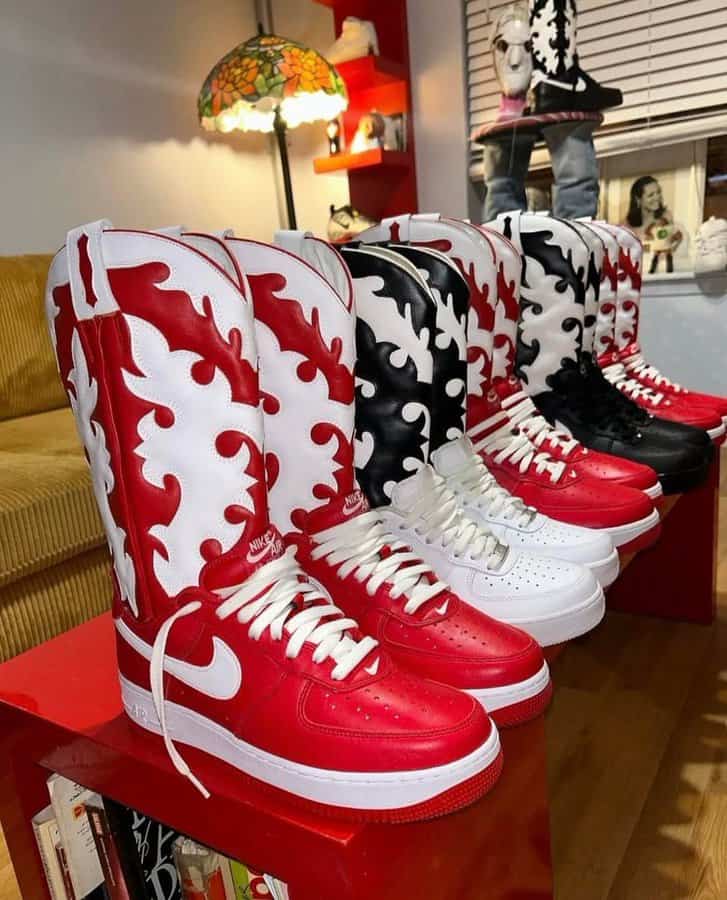 Four pairs of Nike high-top sneakers with flame designs in red, black, and white, displayed on a red.