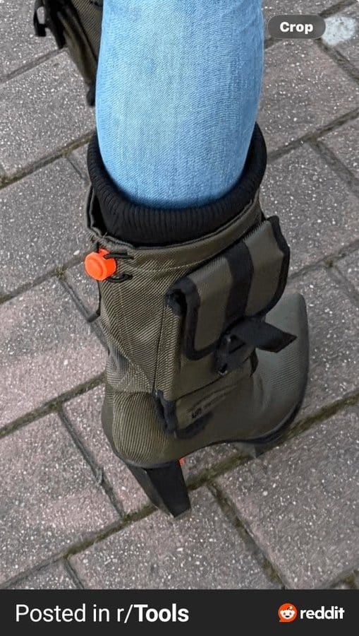 A person wearing jeans and a boot with a small pouch attached.