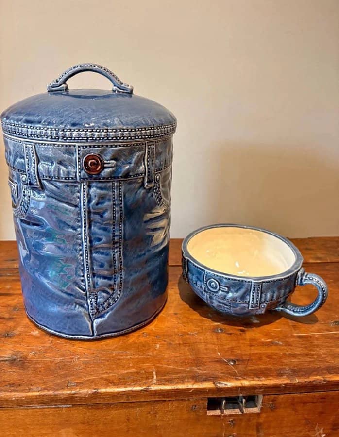 A denim-themed container and matching cup on a wooden surface.
