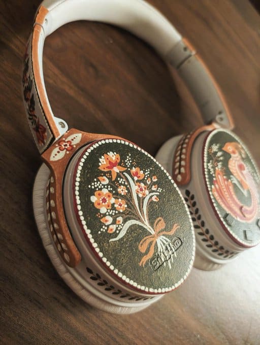 Decorative headphones with floral and traditional design elements.