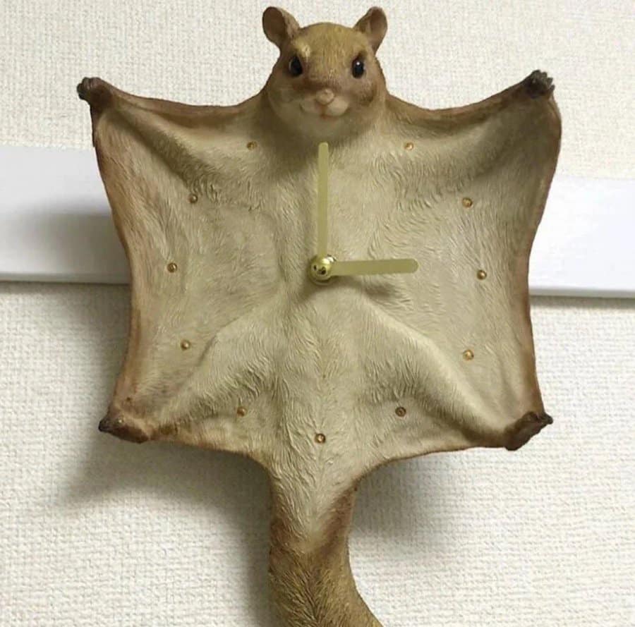 Clock made from a bat with a squirrel face on top.